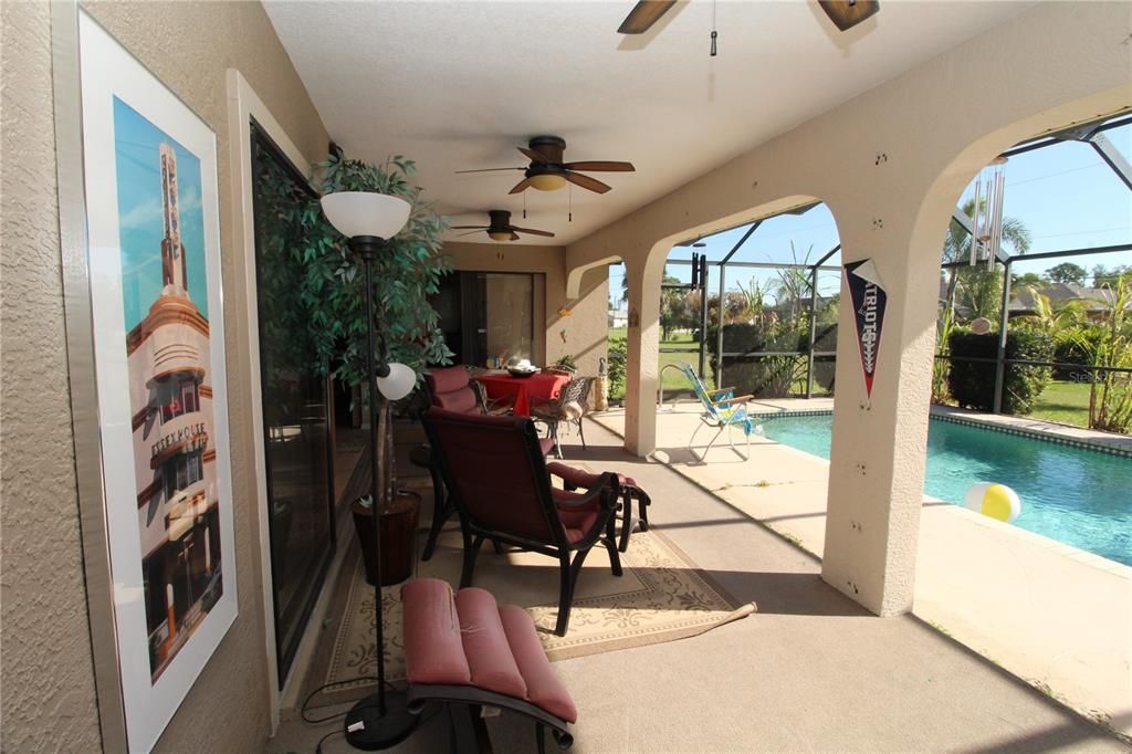 Long Covered lanai area with 3 ceiling fans....
