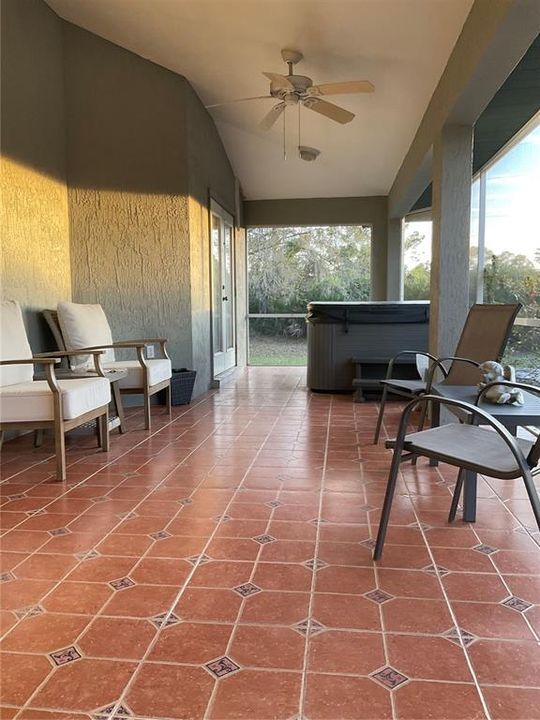 Tiled lanai with double French doors and hot tub