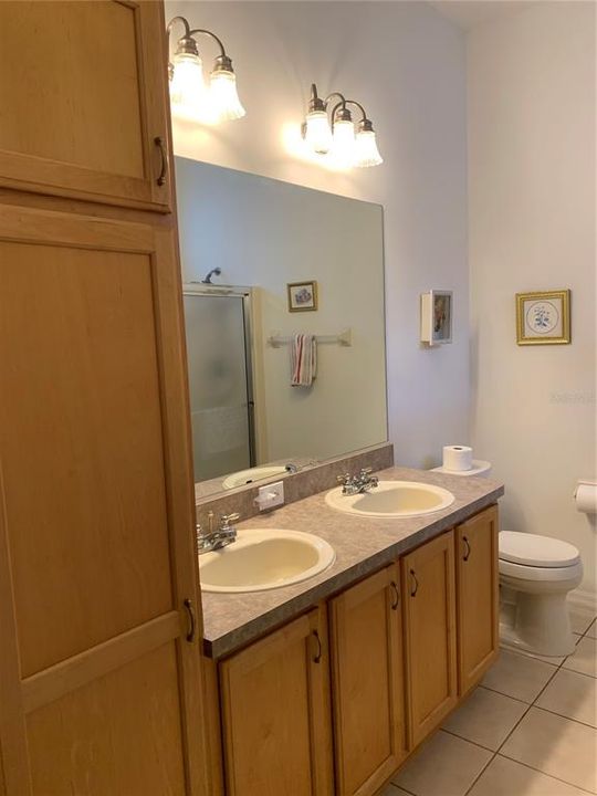 double sinks in master bathroom with extra cabinets for storage