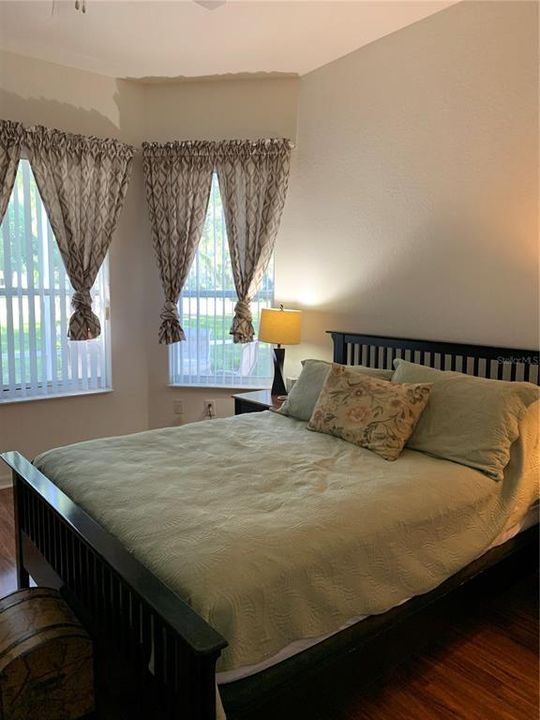 King size master bedroom in rear of house.  Lots of windows and light bright sunny room over looking the golf course/pool area