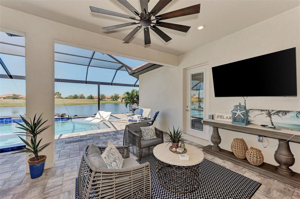 The outside lanai has multiple entertaining areas-this area has television