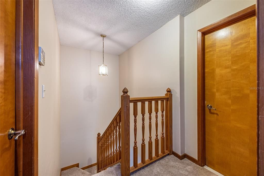 The primary bedroom is 15’x11’ and boasts vaulted ceilings, a spacious 5'x6' walk-through closet leading to a private vanity with sink, and direct access to the shared full bath.