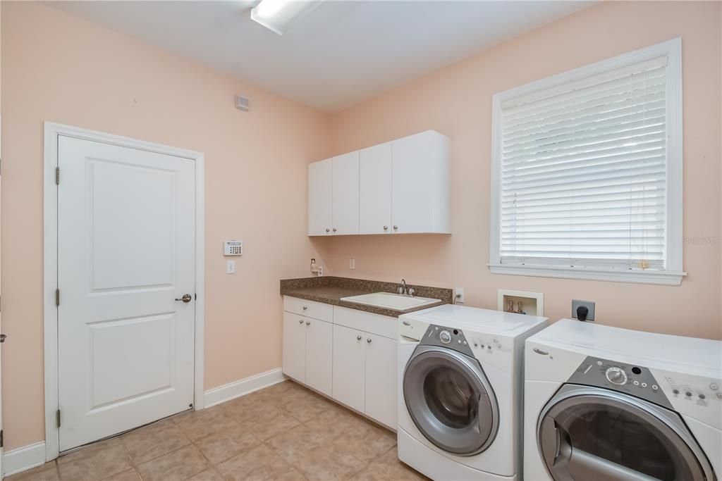 Laundry Room with Washer, Dryer, Utility Sink, Pantry and Additional Storage