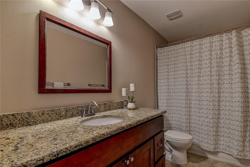 The second bathroom conviently located from the two rooms and your guests. This one has a tub with a shower.