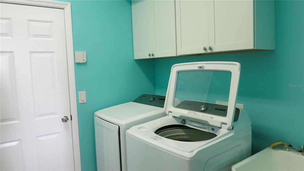 Laundry Room with Cabinetry & Utility Sink