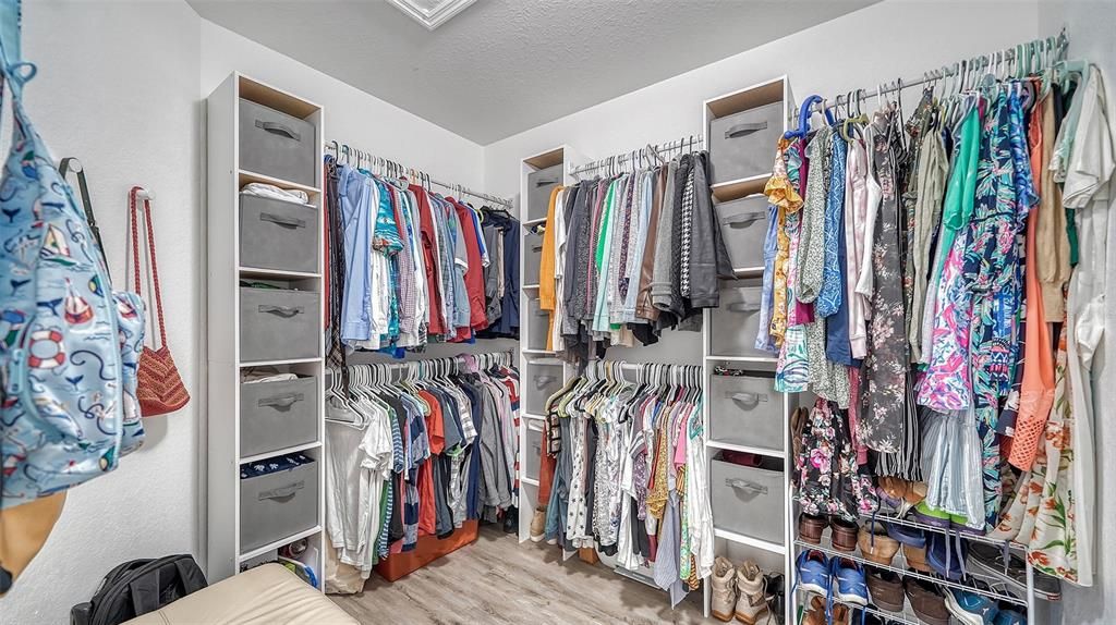 The walk-in closet has been updated to include a useful closet system.