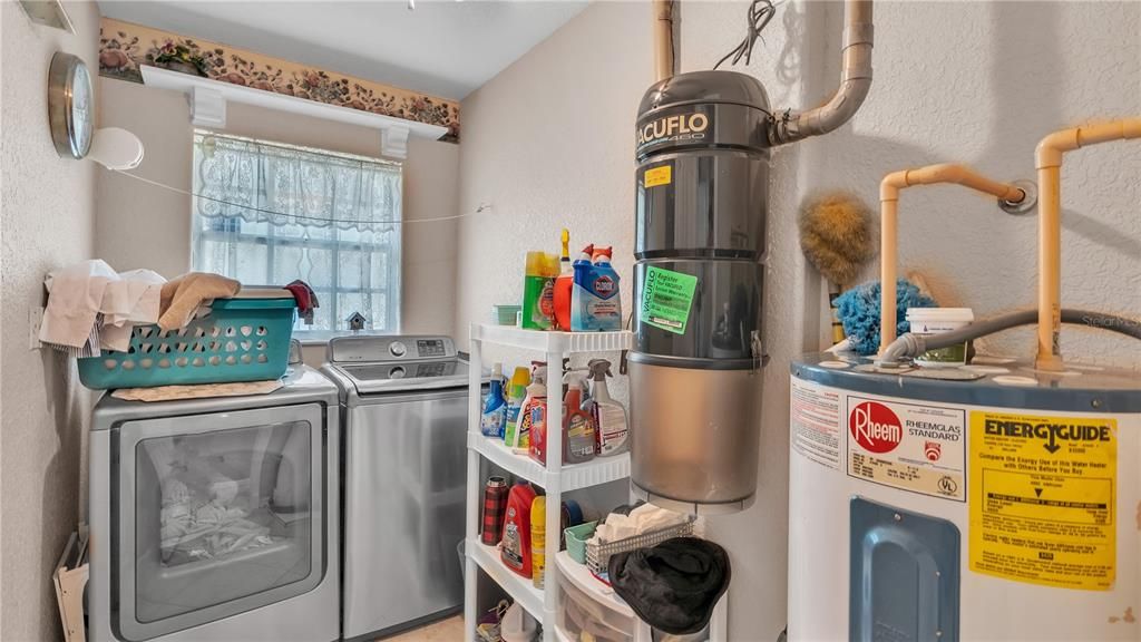 Laundry room with water heater and central vacuum