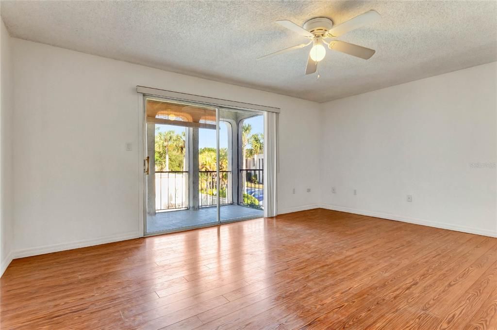 Your generous living room has the same WOOD LAMINATE FLOORS as your primary suite and offers sliding glass door access to a nice sized balcony that includes additional storage!
