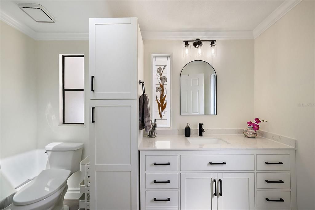 Renovated primary ensuite with custom cabinetry.