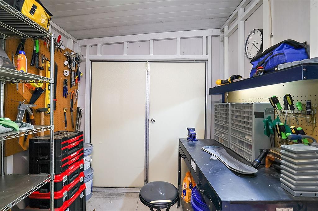 Double door and single door entry to golf cart garage/workshop.