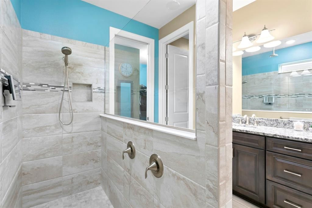 The large walk-in shower in the master bath features multiple shower heads