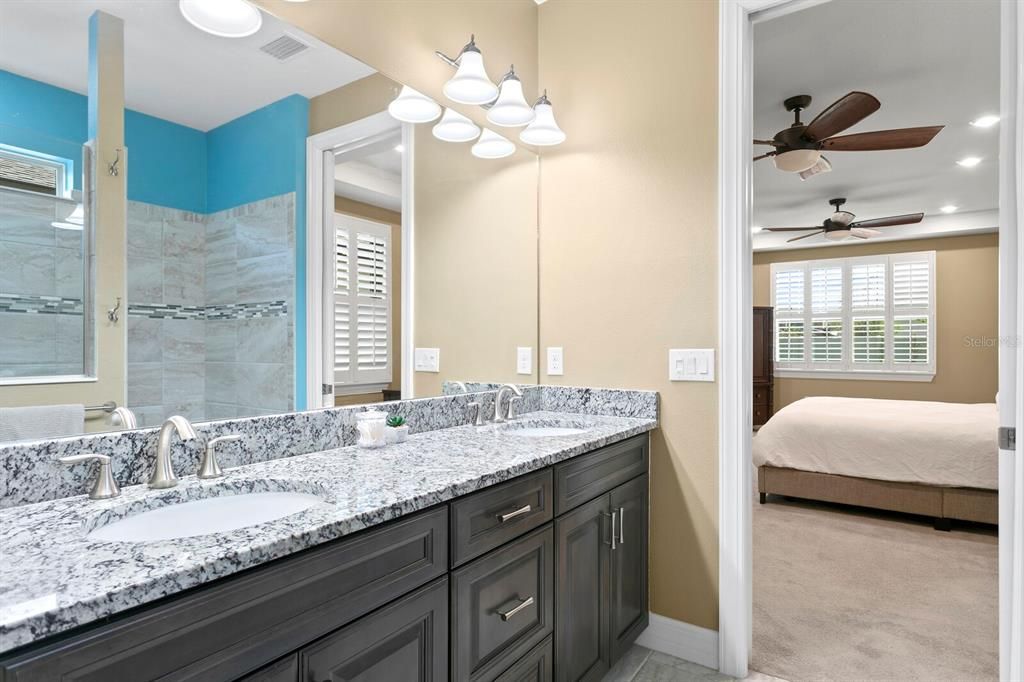 The spacious master bath includes thick granite counters