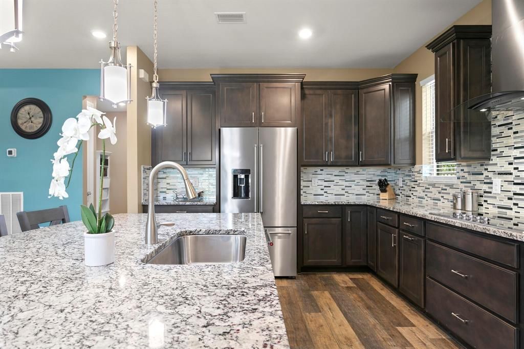 Thick granite counters throughout the kitchen