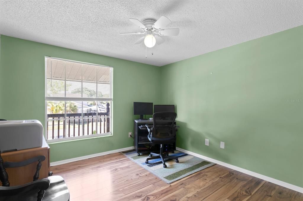 1st bedroom features laminate wood floors & is being used as a private office