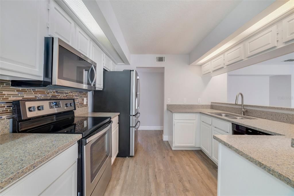 The home chef will appreciate the ample cabinet and counter space, quality appliances, decorative backsplash and a pantry for even more storage!