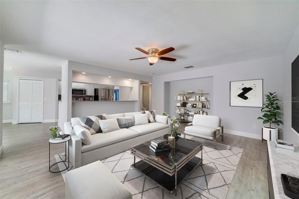 Follow the natural flow into the generous family room where you will find one of several sets of sliding glass doors to access the lanai/pool, all open to the lovely kitchen in the heart of the home. Virtually Staged.