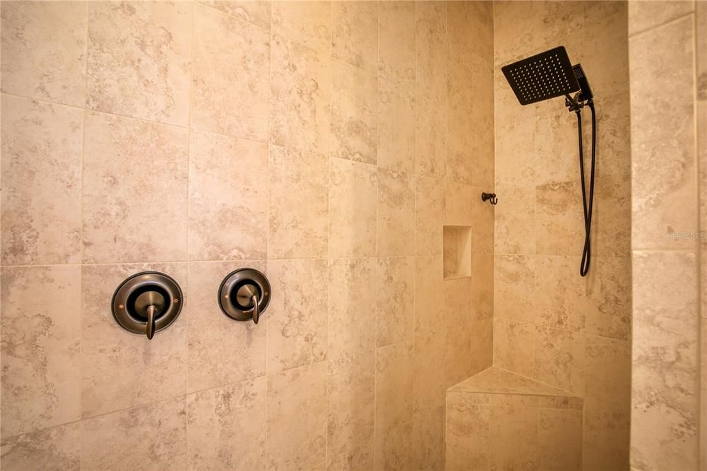 Large walk in shower with built in bence