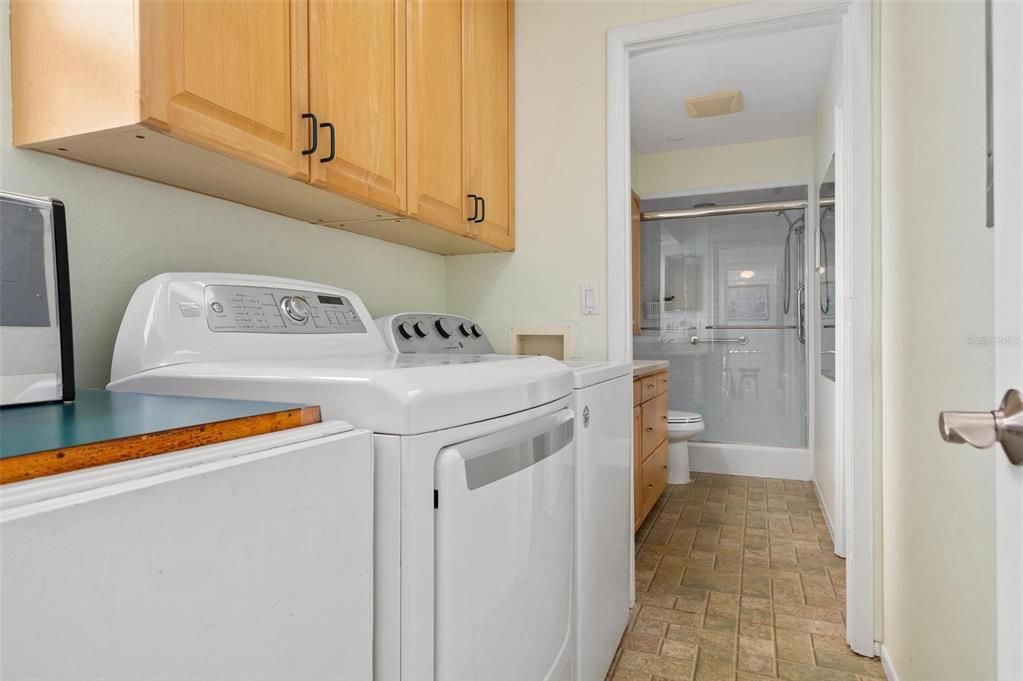 Laundry room with full size washer and dryer and reverse osmosis