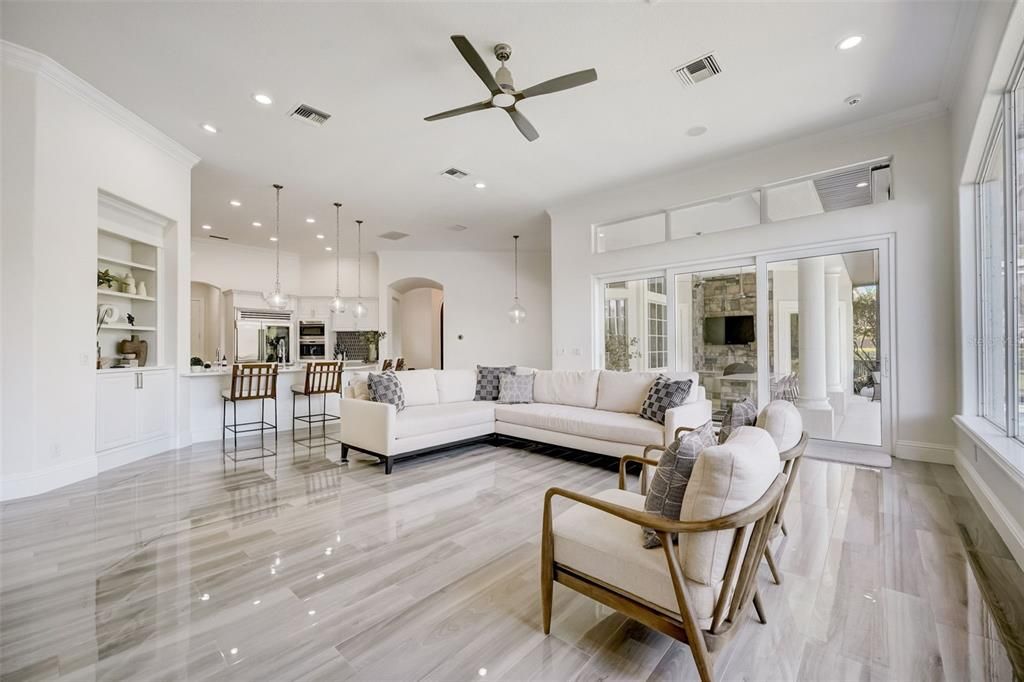 Follow the natural flow from the formal spaces into an entertainer’s dream kitchen and a family room with a wall of sliding glass doors that open up to your covered lanai, Summer kitchen and heated pool!