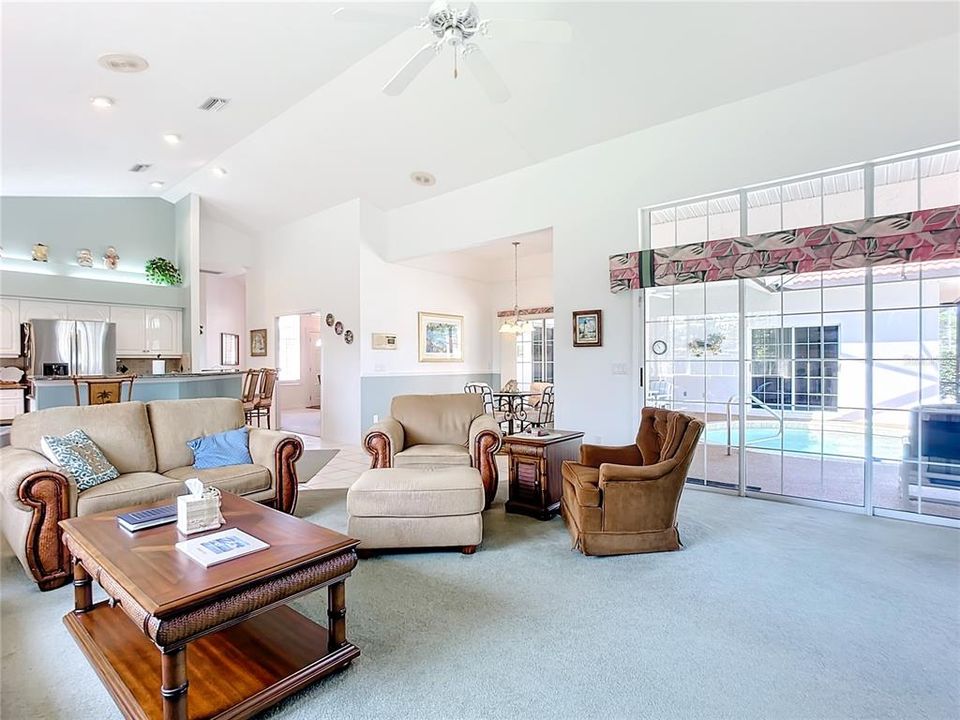 Family room opening to Pool area. 12 feet of sliding doors with fixed eyebrow glass above