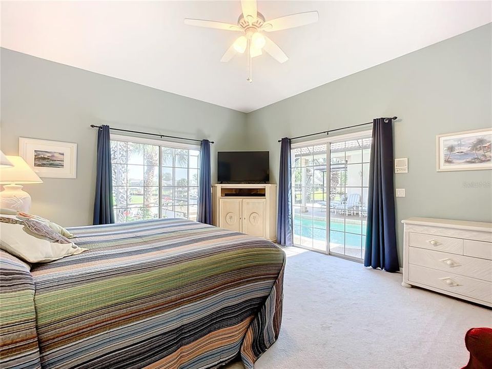 Primary Bedroom with 2 sliding glass doors leading to pool and canal.