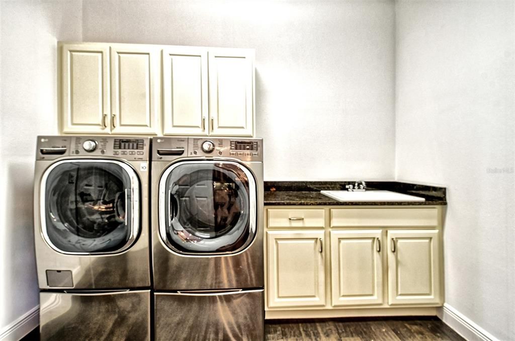 Laundry room with newer appliance and laundry sink