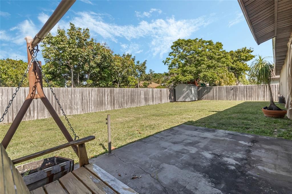 Relax on back patio and enjoy the view of your fenced in backyard.