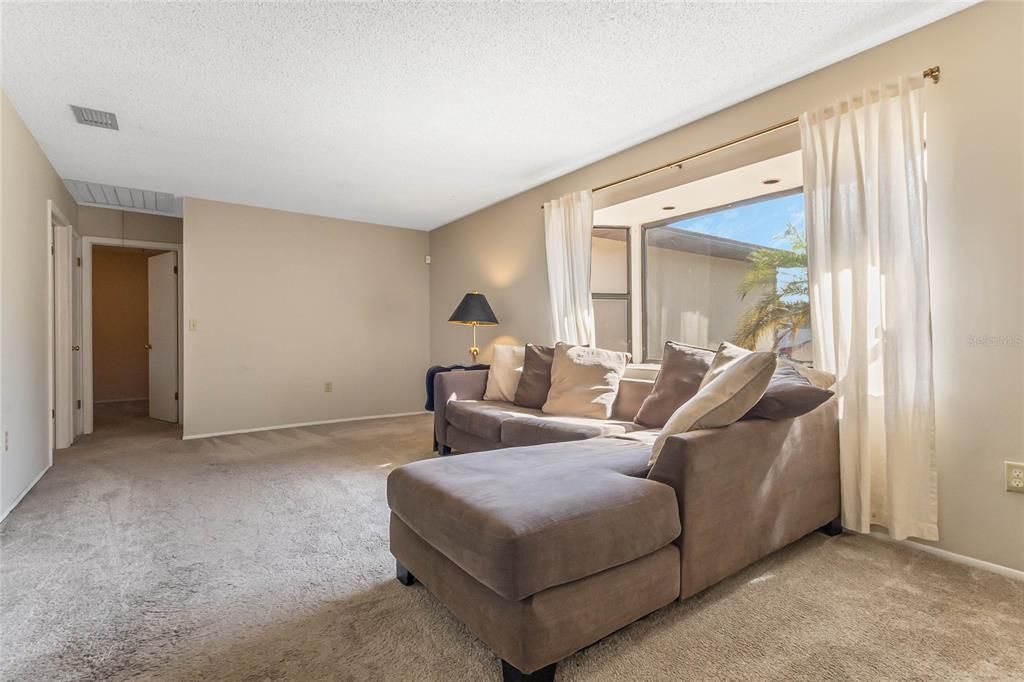 Living Room looking towards bay window and hallway to 2 bedrooms