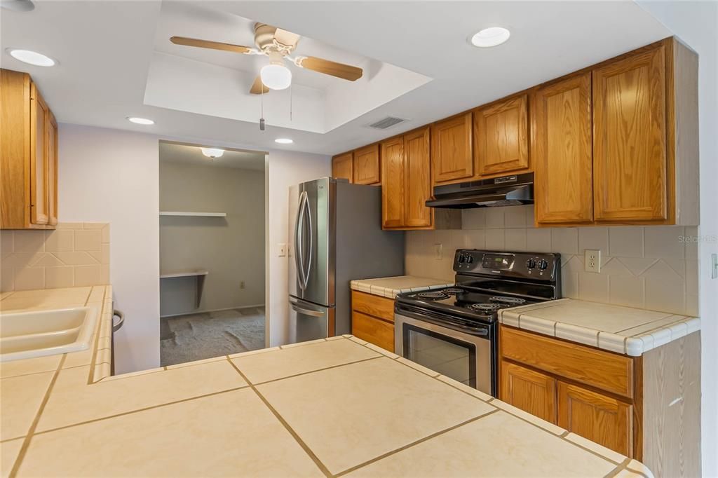 Kitchen has oak cabinets and stainless appliances