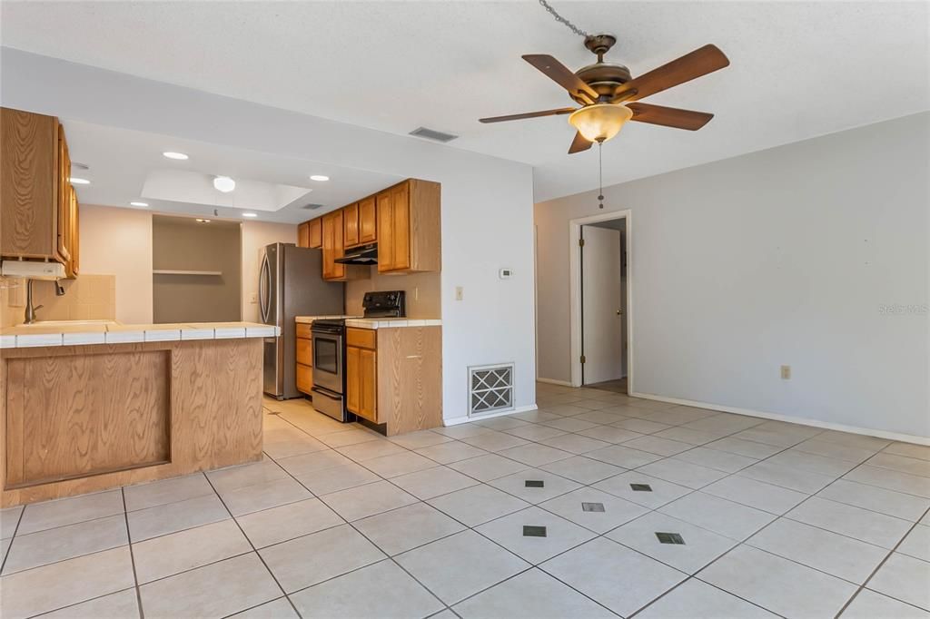 Family room facing kitchen and door to Primary Bedroom