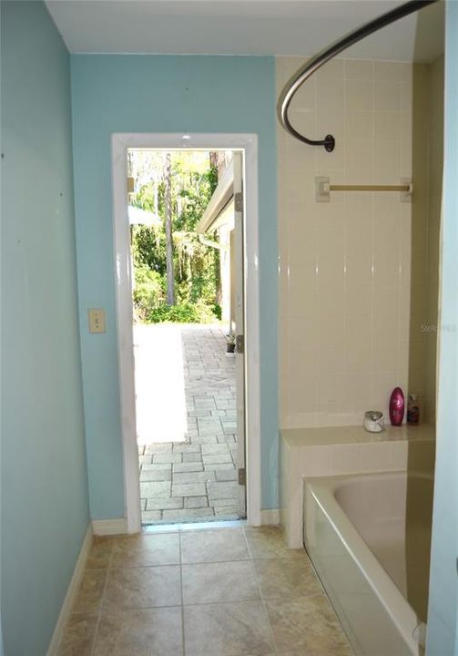 Second bathroom with door to the pool area