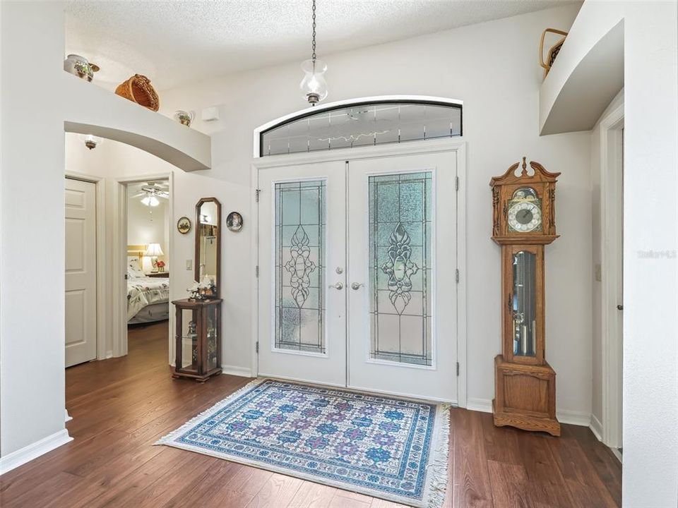 Spacious Entry featuring high ceilings and double glass front doors