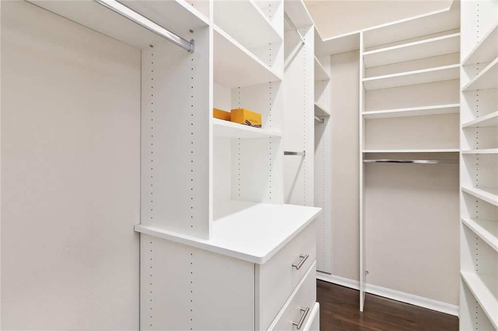 Primary suite closet with upgraded built-in shelving and motion lights