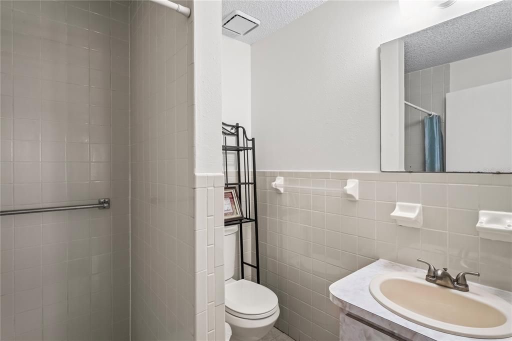 Primary en-suite bath has shower, no tub, and a single vanity.