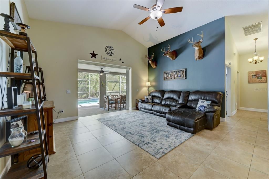 LARGE FAMILY ROOM - OPEN FLOOR PLAN. TRIPLE SLIDERS LEAD OUT TO THE POOL AREA