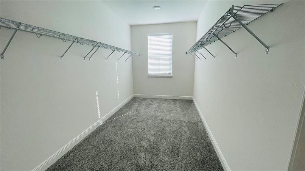 large walk-in closet in the master bedroom with window
