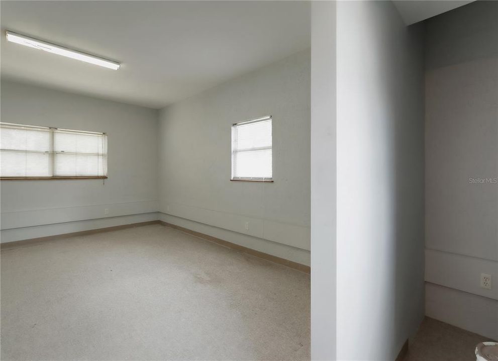 Flex space (400 sqft) with high ceilings, private exterior entrance/exit, and sink/plumbing.