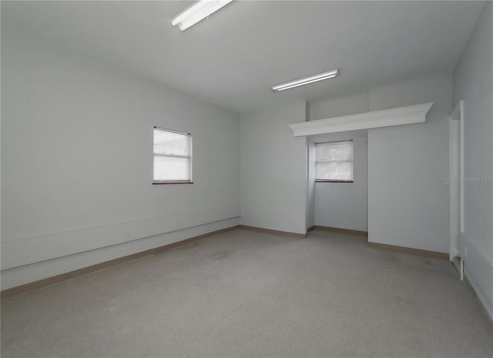 Flex space (400 sqft) with high ceilings, private exterior entrance/exit, and sink/plumbing.