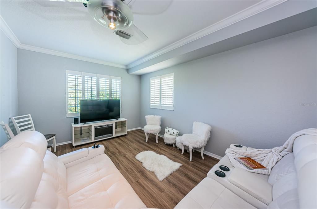 Family Room with Plantation Shutters facing back of property