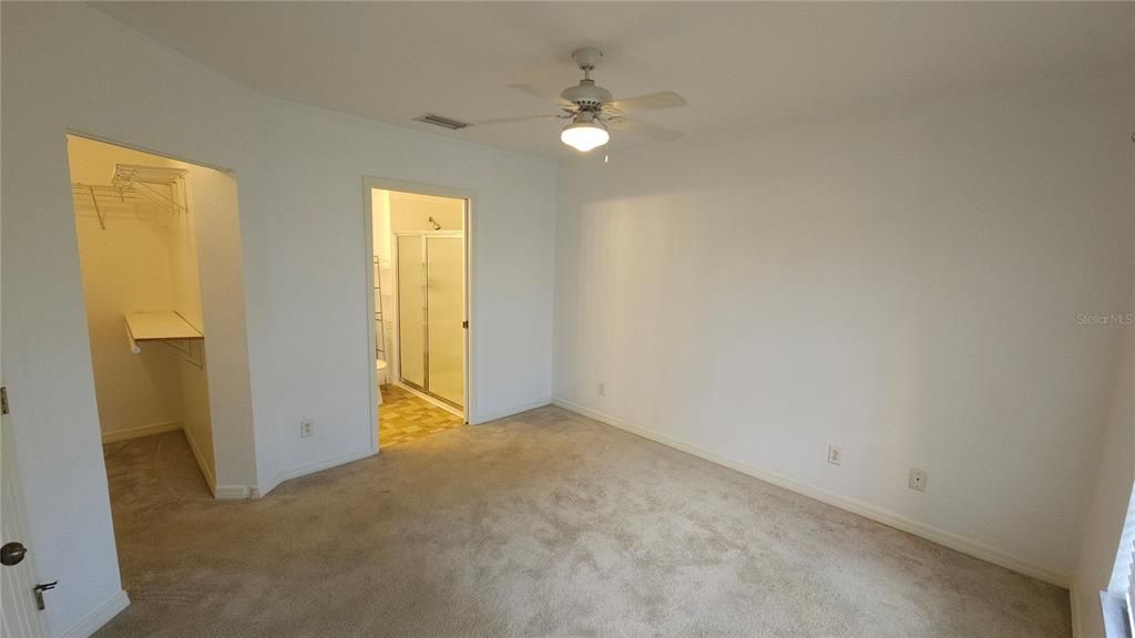 Primary bedroom walk-in closet