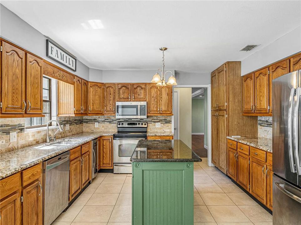 All SS appliances, granite counters and wood cabinets