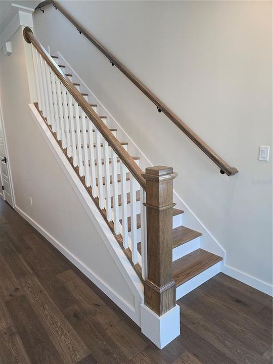 Hardwood floors and oak stairway