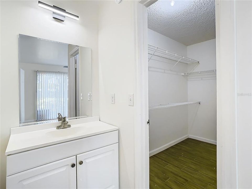 Vanity and view of walk-in-closet