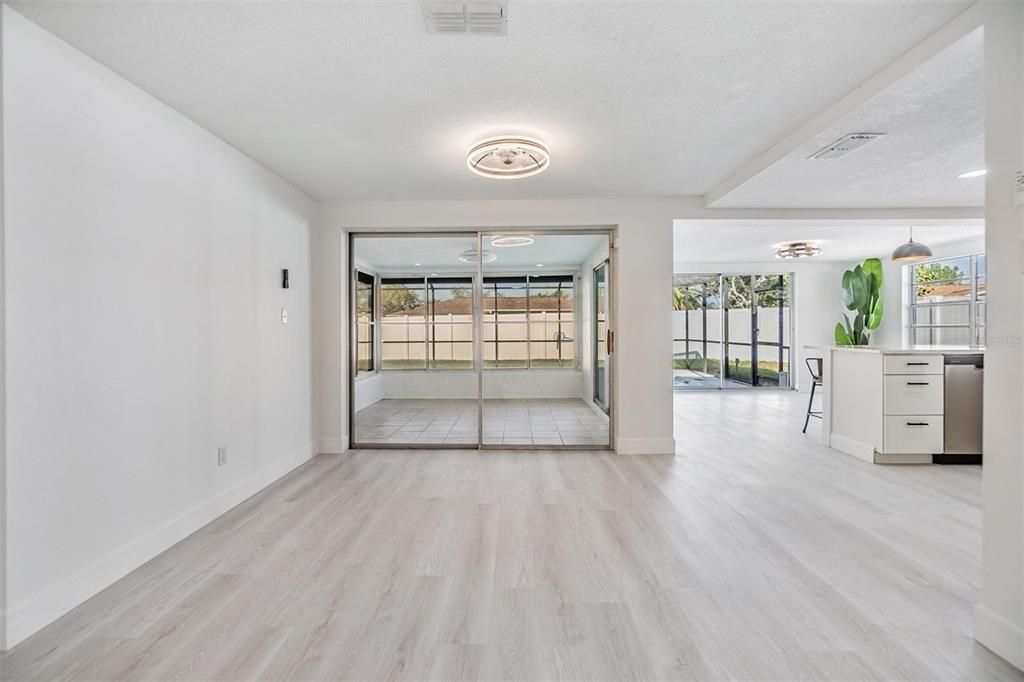 Dining room. Sliders to flex/bonus room and entrance to kitchen.