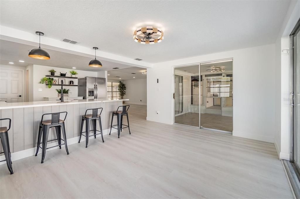 A great room for a family room for dining area.  2 sliders to patio / pool area.  Light and fan on the ceiling.