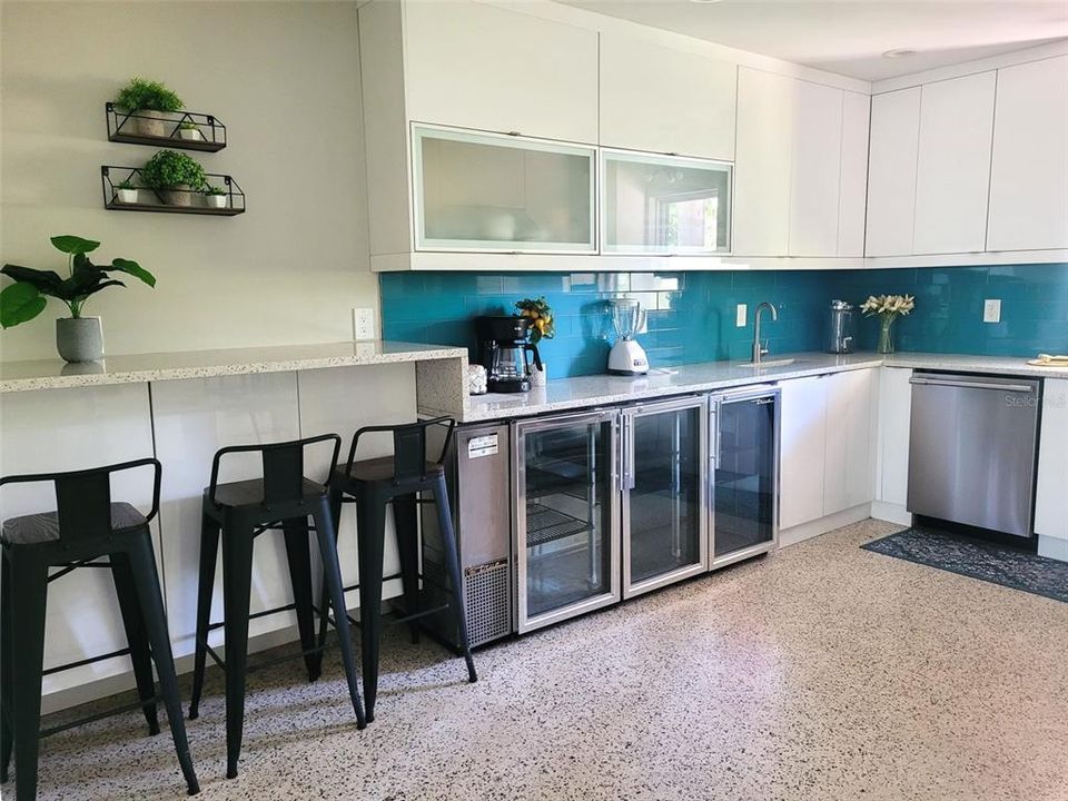 Our kitchen is just to the right of the front entry living room area. There is a wine bar, full size fridge, oven range, dishwasher, microwave provided