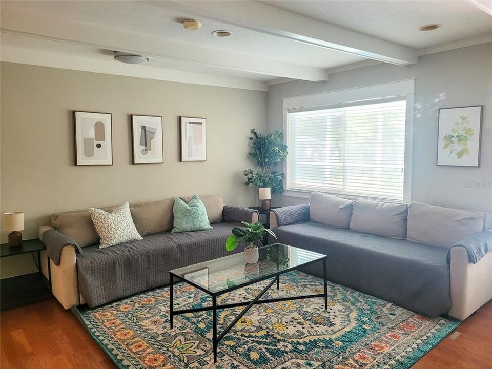 The second living area is just off from the kitchen and can easily fit the entire family in one large room for enjoying TV. You can also make this the dining area if desired. This living room area also has direct access to the pool area and outdoor patio area with additional outdoor dining