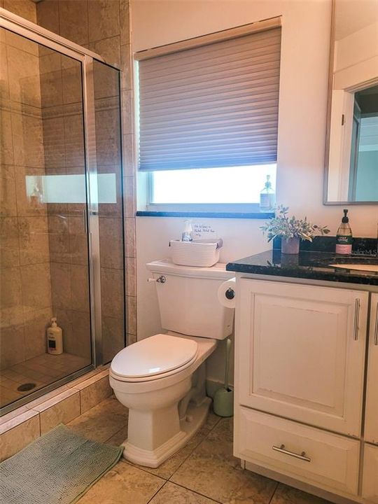 Our dedicated bathroom on the opposite side of the home just past the laundry room and next to the additional third King guest bedroom. This bathroom features a stand up shower and small linen closet
