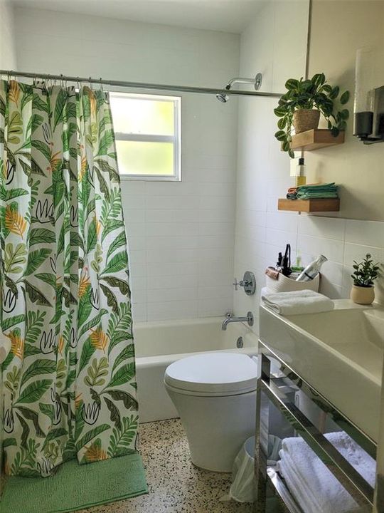 The guest bathroom features a shower / tub combo perfect for little ones