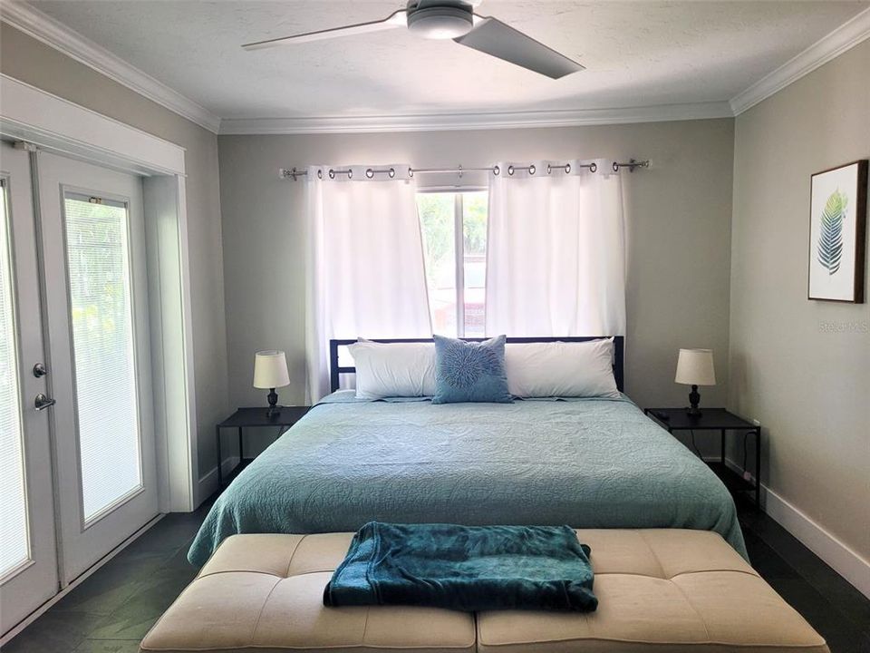 Large king guest bedroom with direct access to private porch and fire pit area
